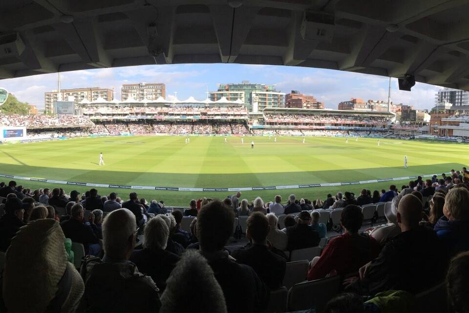 A cricket stadium filled with spectators.