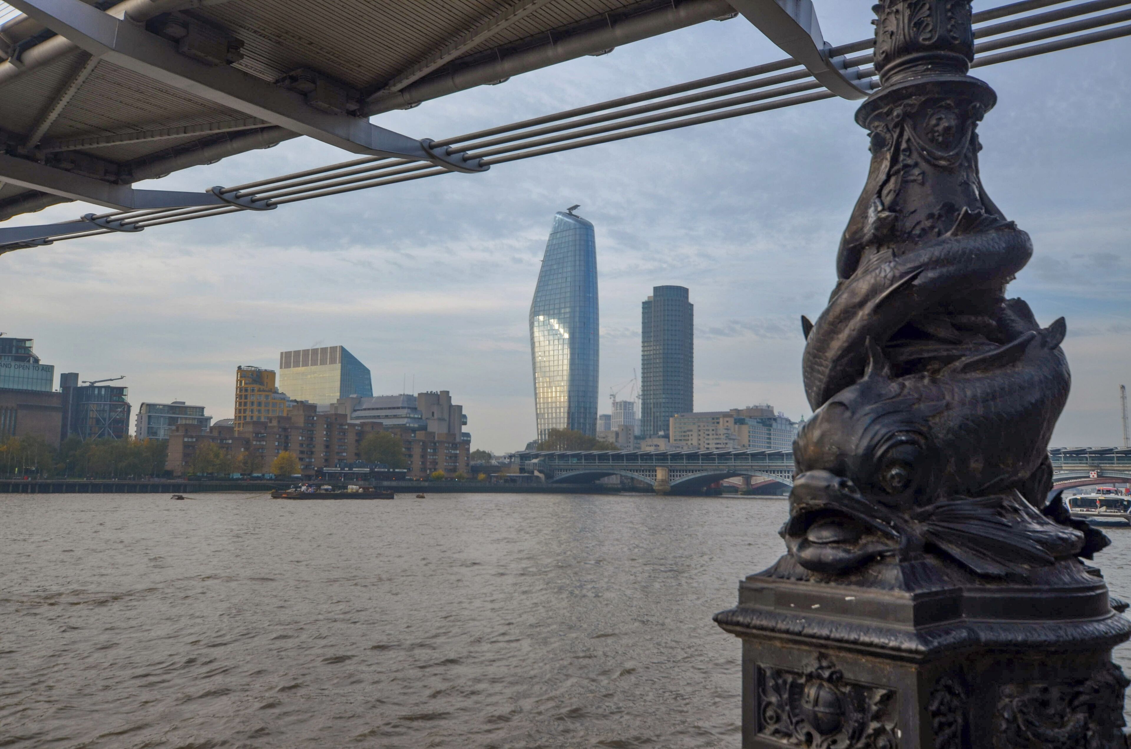 View looking west under the Millennium footbridge of the ever developing London skyline.