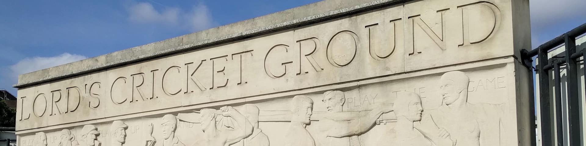 A stone monument with the inscription "Lord's Cricket Ground" and relief sculptures of cricket players.