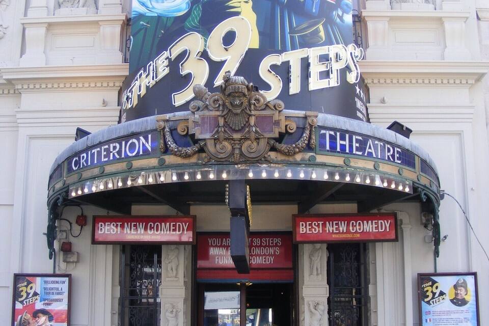 The exterior of The 39 Steps theatre with a large poster advertising the Olivier Awards.