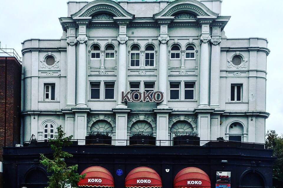 A large, historic building with a prominent dome and the word "KOKO" displayed on the facade.