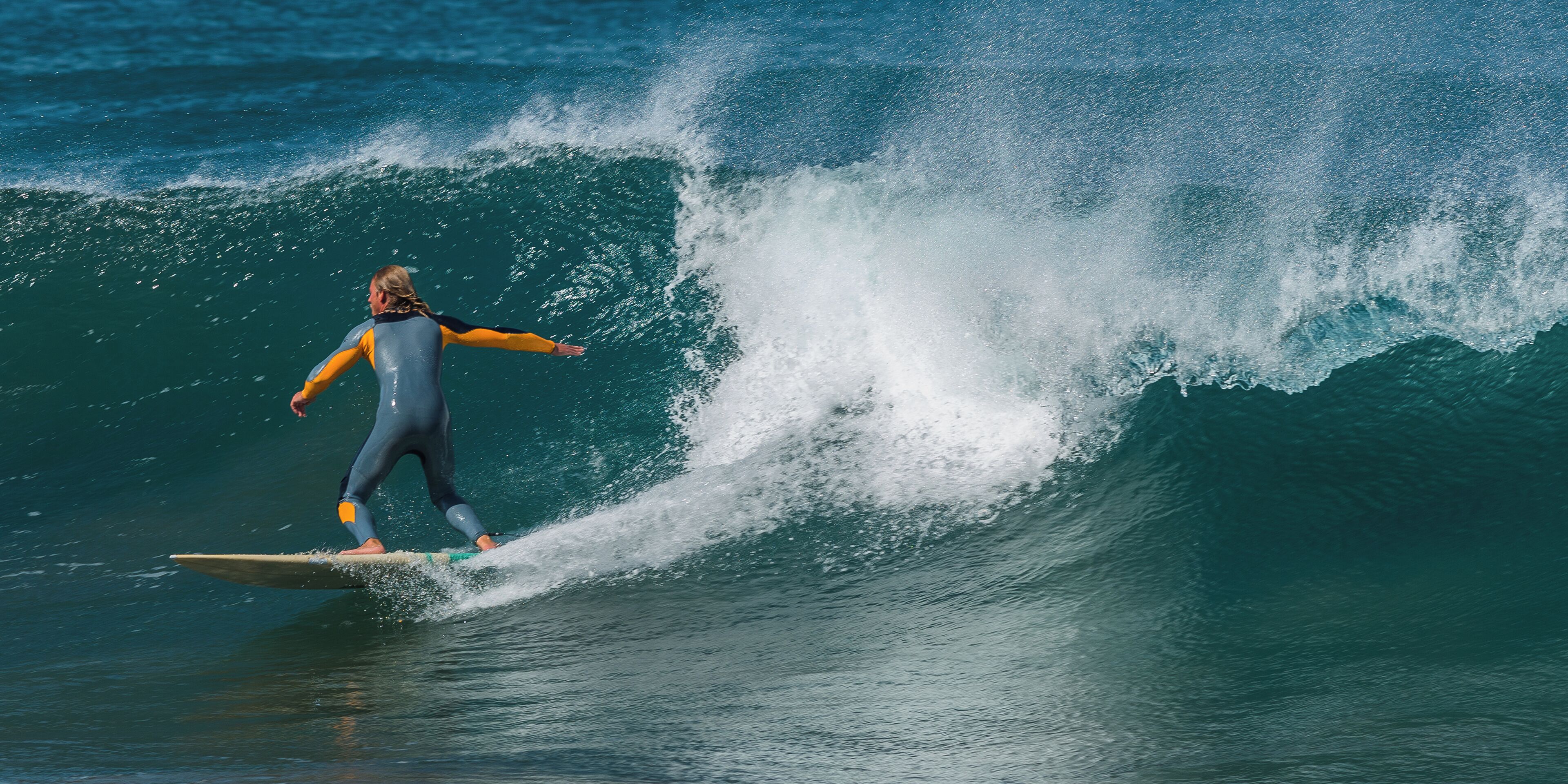 Un surfeur chevauchant une grosse vague.