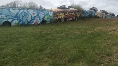 The painted school buses form a fence around a junk yard. Be aware that you just park along the road and go up the hill to get there. I think you can tour the yard but it’s only open mon - fri 8-5 pm.
