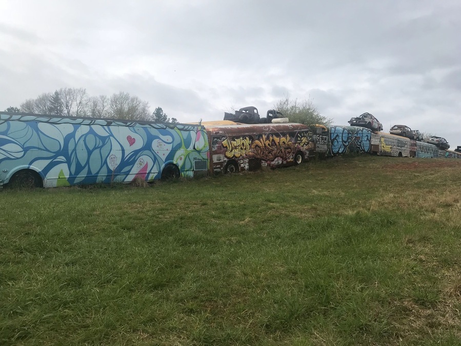 The painted school buses form a fence around a junk yard. Be aware that you just park along the road and go up the hill to get there. I think you can tour the yard but it’s only open mon - fri 8-5 pm.