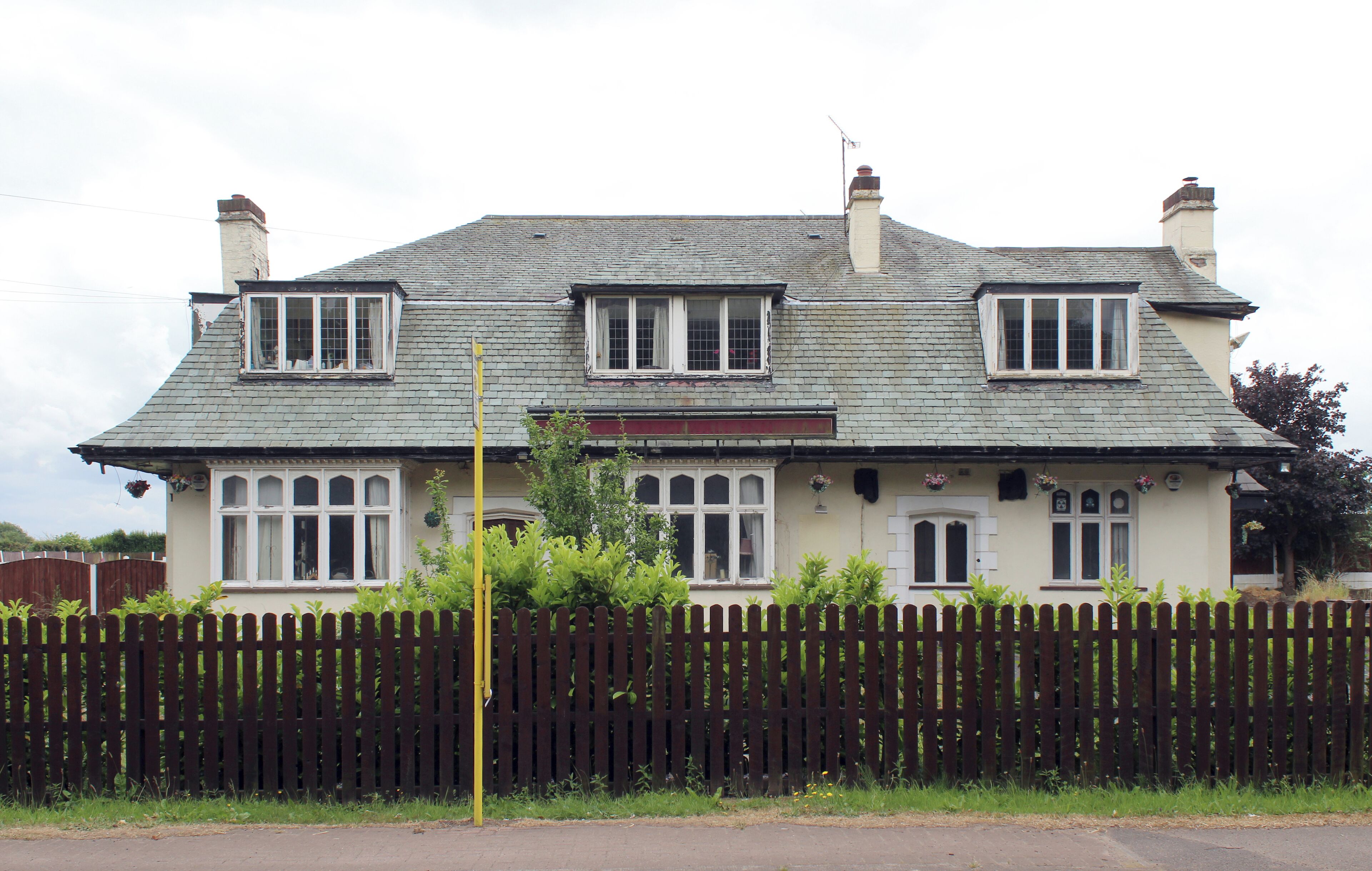 There has been a public house on this site since the 17th century, with associated brewery across Netherley Road. This version is a 1930s roadhouse style, which closed in the early 21st century and is now a cattery.