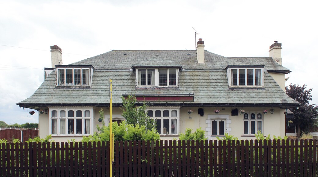 There has been a public house on this site since the 17th century, with associated brewery across Netherley Road. This version is a 1930s roadhouse style, which closed in the early 21st century and is now a cattery.