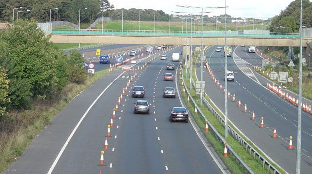 M62 at Tarbock Island View eastwards from the roundabout level. The bridge visible was built to carry the branch railway from Cronton Colliery.