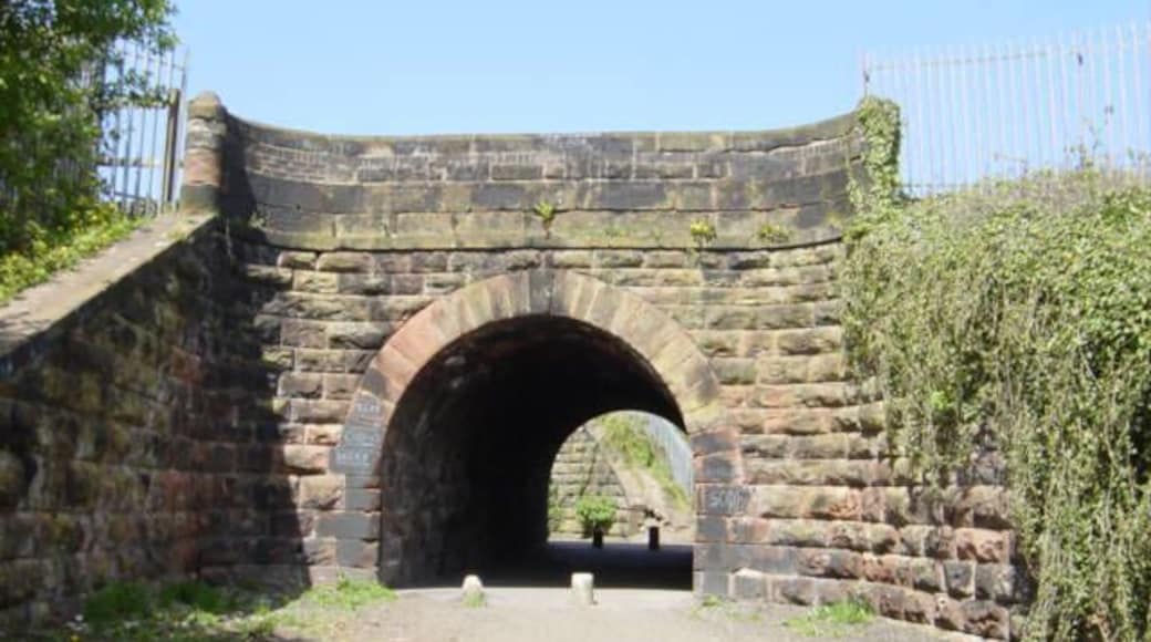 Railway Bridge near Sawpit Park This sandstone bridge, just beyond Huyton Junction, gives access under the Liverpool-Manchester line and through it can be seen the second bridge under the Liverpool-Wigan line.The Liverpool and Manchester line opened on September 15th 1830, the world's first intercity passenger railway in which all the trains were timetabled and operated, for most of the distance, solely by steam locomotives.