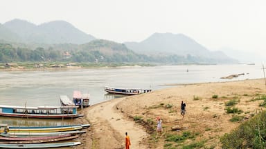 Bamboo Bridge over Nam Khan river in a lush tropical landscape in Luang Prabang, Laos.