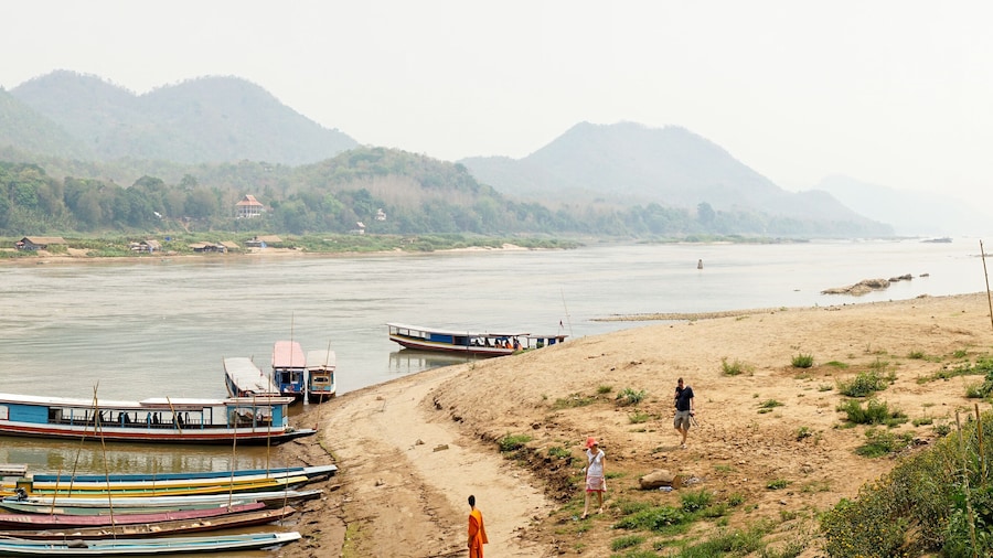 Bamboo Bridge over Nam Khan river in a lush tropical landscape in Luang Prabang, Laos.