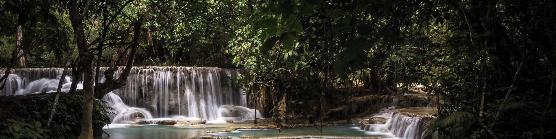 There is a whole series of these cascading waterfalls at Kueng Si waterfalls, near Luang Prabang in Laos. Worth a visit, go early if you want photos without people swimming in it.