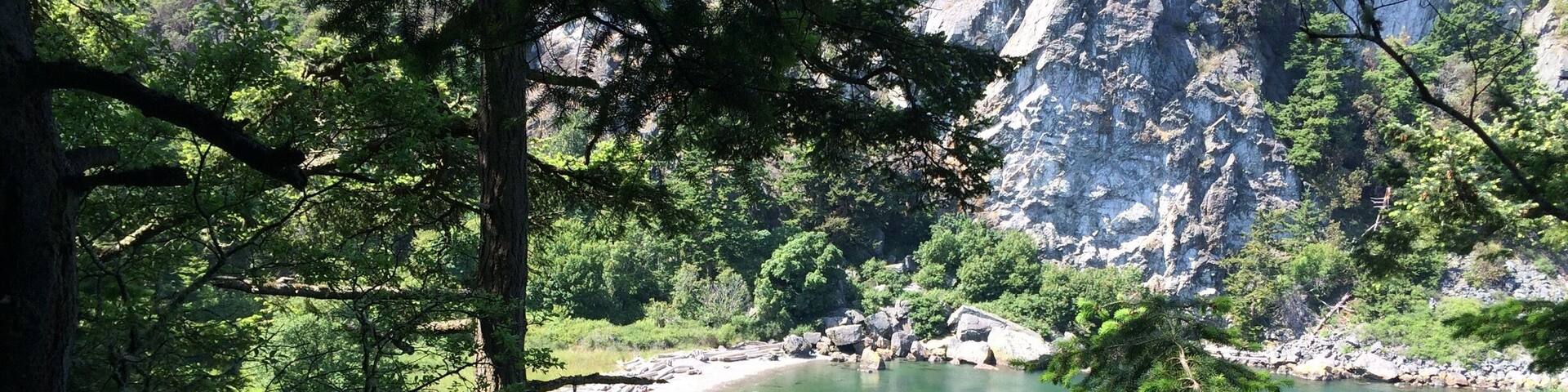 This is Watmough Beach on Lopez in the San Juans. Beautiful peaceful beach with cliffs above and short kid friendly trails as well. At lower tides take the trail out to tide pools and perfect skipping stones that have formed from the currents! I love this place!