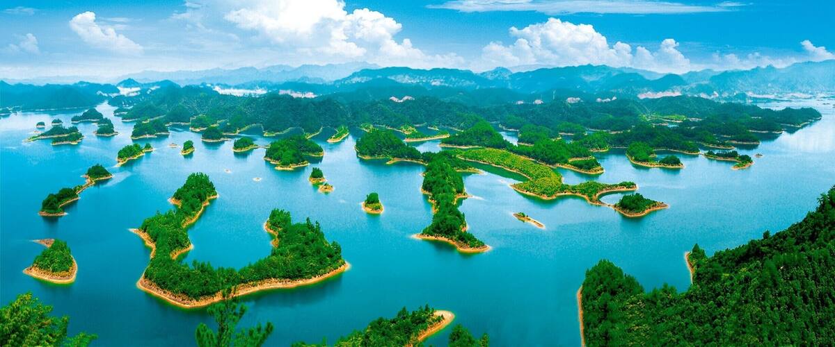A vast archipelago with numerous islands surrounded by clear blue waters and lush green landscapes.