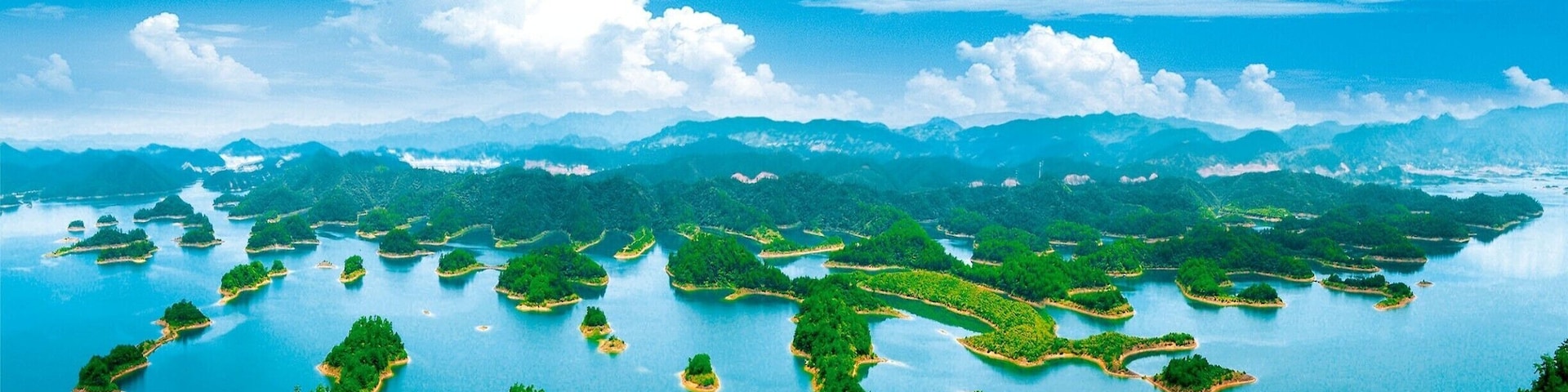 A vast archipelago with numerous islands surrounded by clear blue waters and lush green landscapes.