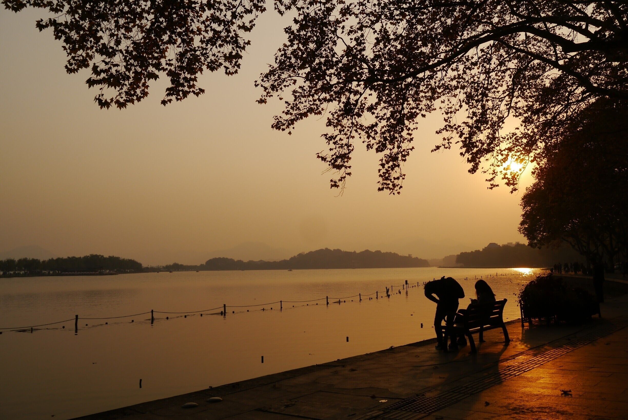 As couples holding hands are walking up and down the pathway, tourists are struggling to get their cameras out to seize this beautiful moment, while local businessman are strolling along, attempting to avoid the craze. 
West Lake in Hangzhou is absolutely stunning at sundown. Take a day trip from Shanghai, or simply stay here for a couple of days.