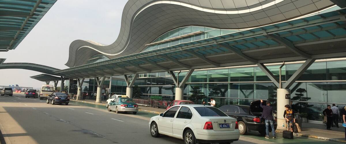 A modern building with a curved roof and glass facade.