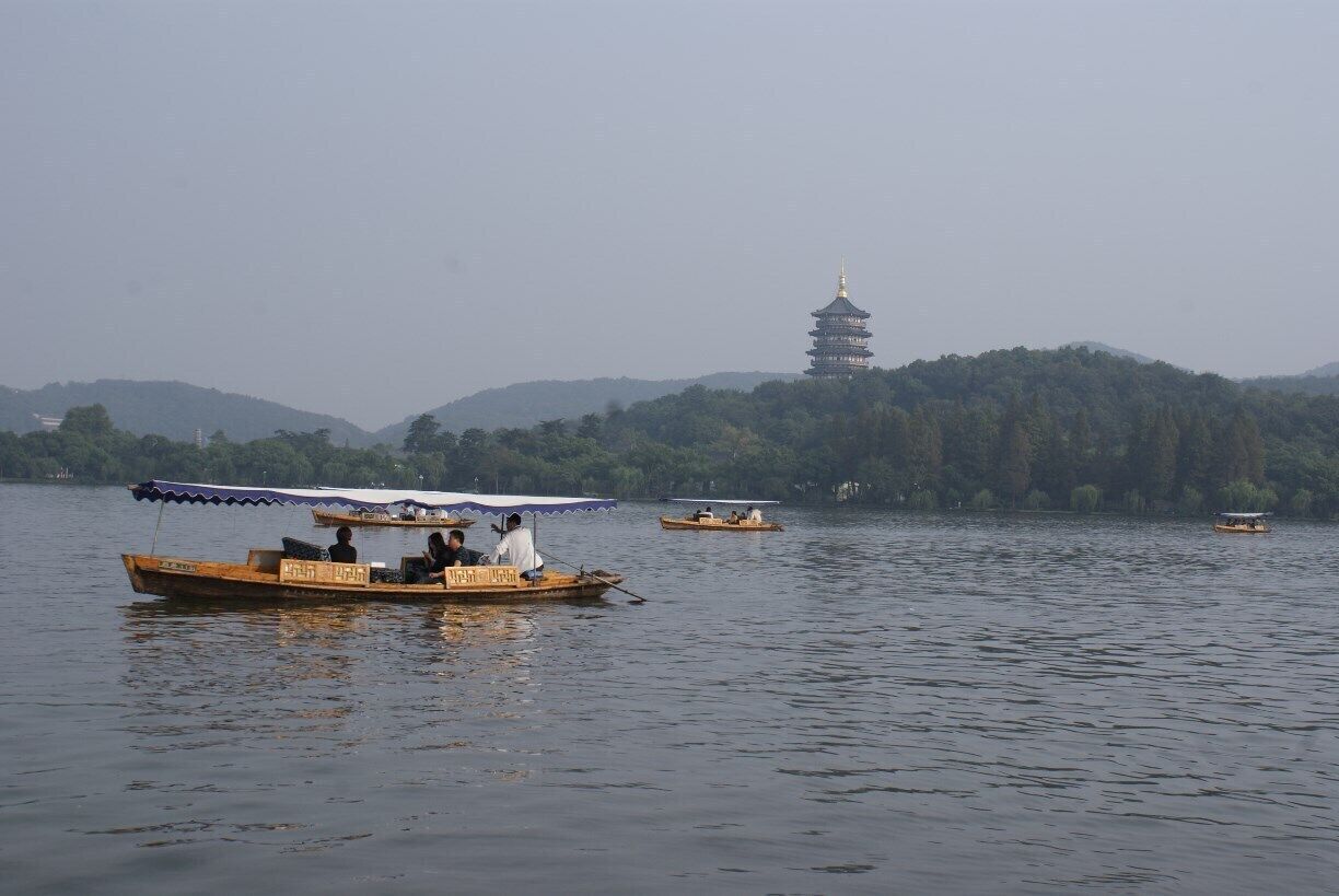 Tour boats on West Lake. There are jewel-like pagodas all around the lake. Our boat was a little bit larger than the ones pictured.
