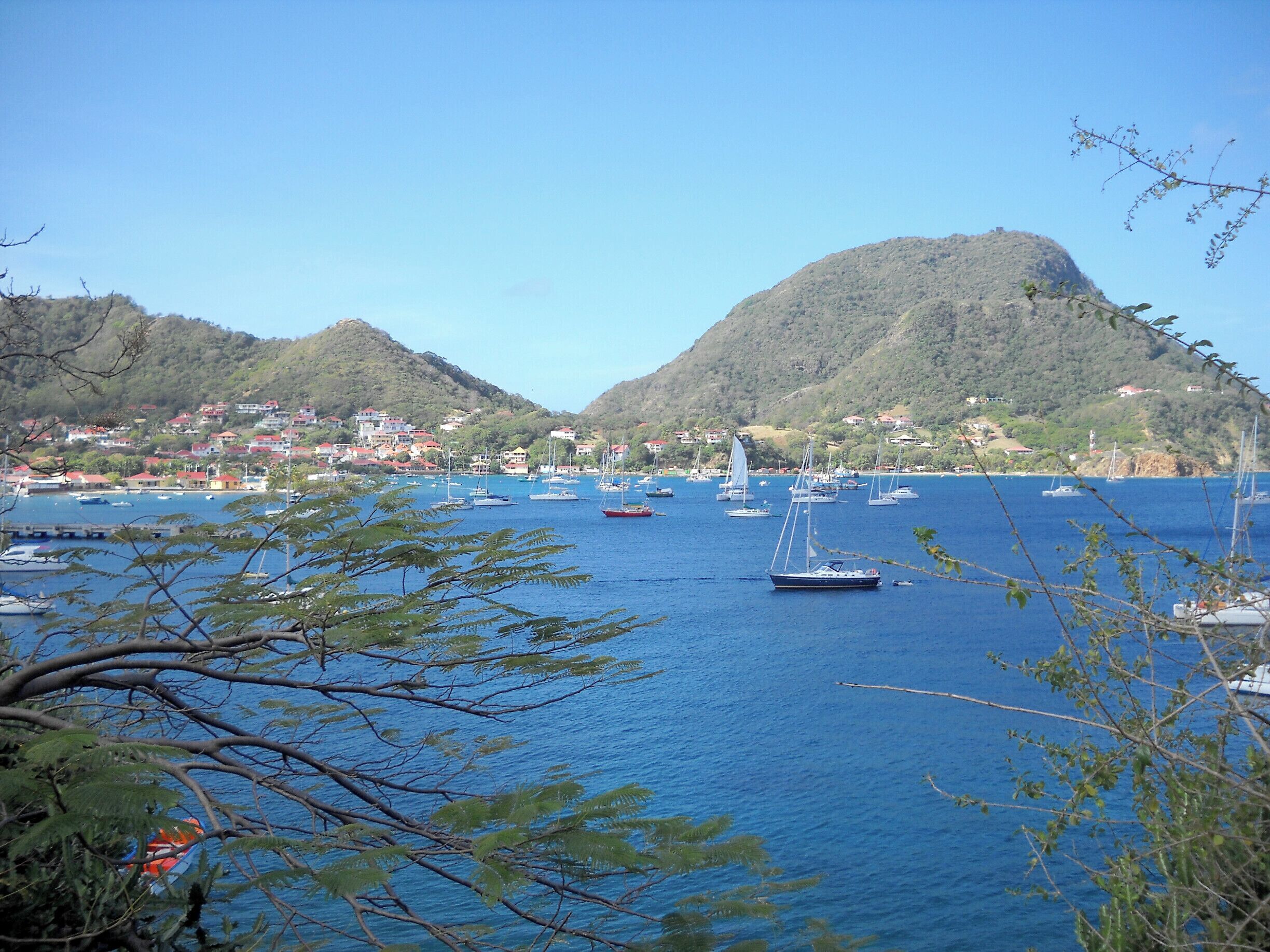 Iles des Saintes, Gaudeloupe, Terre-de-Haut is quiet, and beautiful.  Because of its small size and mountains, Main Street rarely has a car.  Transportation on the island consists primarily of motorcycles and scooters.  It is walkable throughout to the small guest houses, patisseries and beaches.  Connections to the island are by boat from Gaudeloupe and are convenient.  The island is small enough, and remote enough, to be a peaceful respite in a busy world.