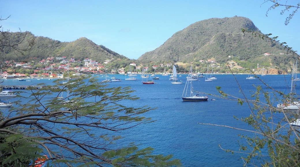 Iles des Saintes, Gaudeloupe, Terre-de-Haut is quiet, and beautiful. Because of its small size and mountains, Main Street rarely has a car. Transportation on the island consists primarily of motorcycles and scooters. It is walkable throughout to the small guest houses, patisseries and beaches. Connections to the island are by boat from Gaudeloupe and are convenient. The island is small enough, and remote enough, to be a peaceful respite in a busy world.