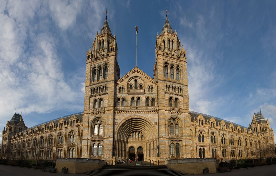 A large, ornate building with two towers and a central archway.