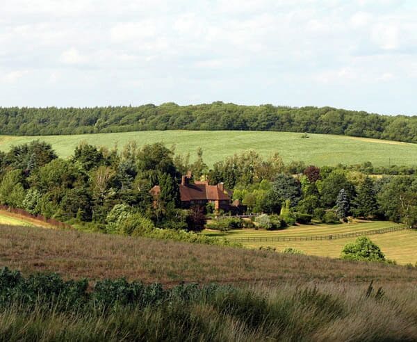 Offley Chase. The house and gardens of Offley Chase sourounded by fields and rolling hills