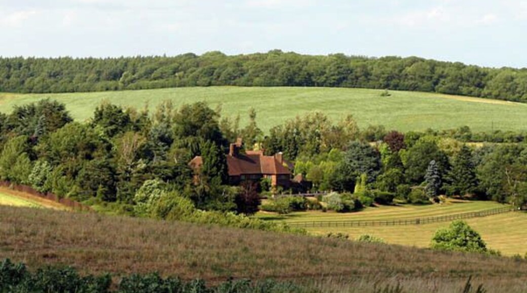 Offley Chase. The house and gardens of Offley Chase sourounded by fields and rolling hills