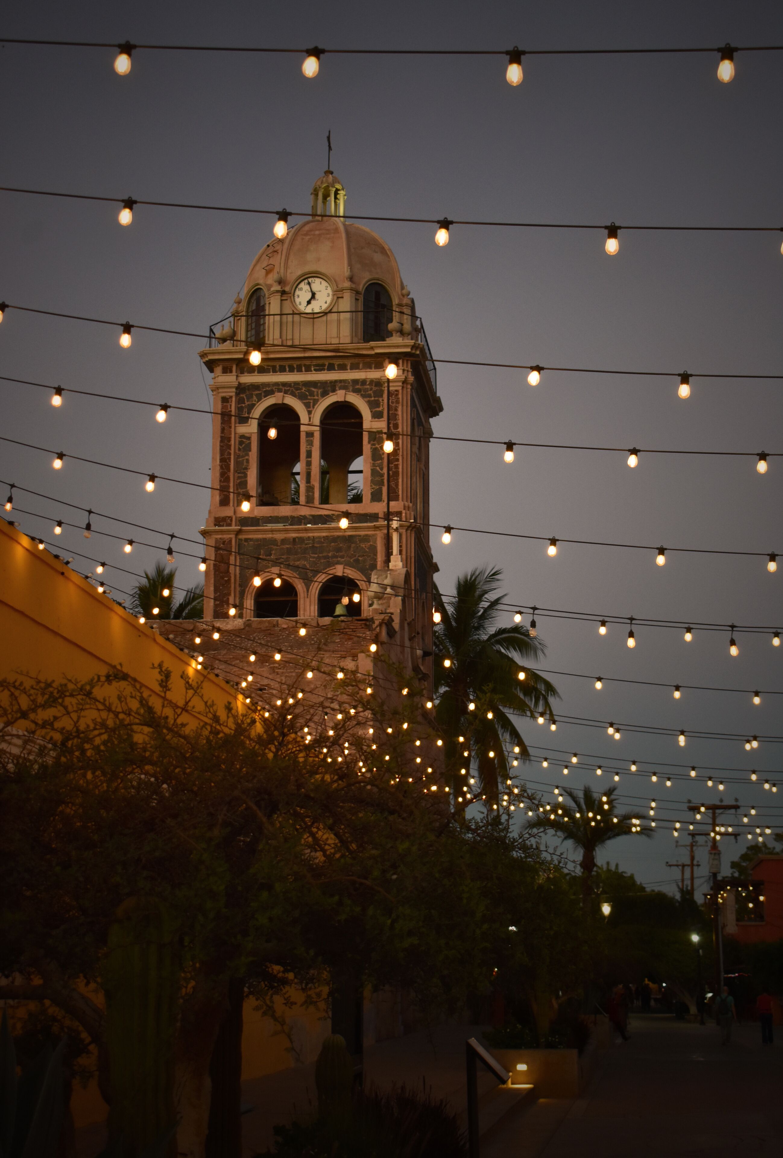 Evening illuminated Church in the city of Loreto, Mexico, Baja California Sur stock photo images. Mision de Loreto vertical photo images. Night Catholic church with a bell tower in Loreto Mexico photo