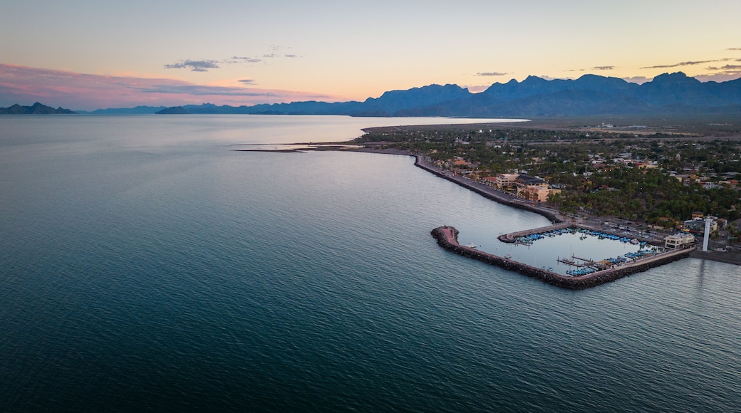 drone fly above Loreto Baja California Sur Mexico old colonial town with sea gulf ocean and mountains desert landscape at sunset