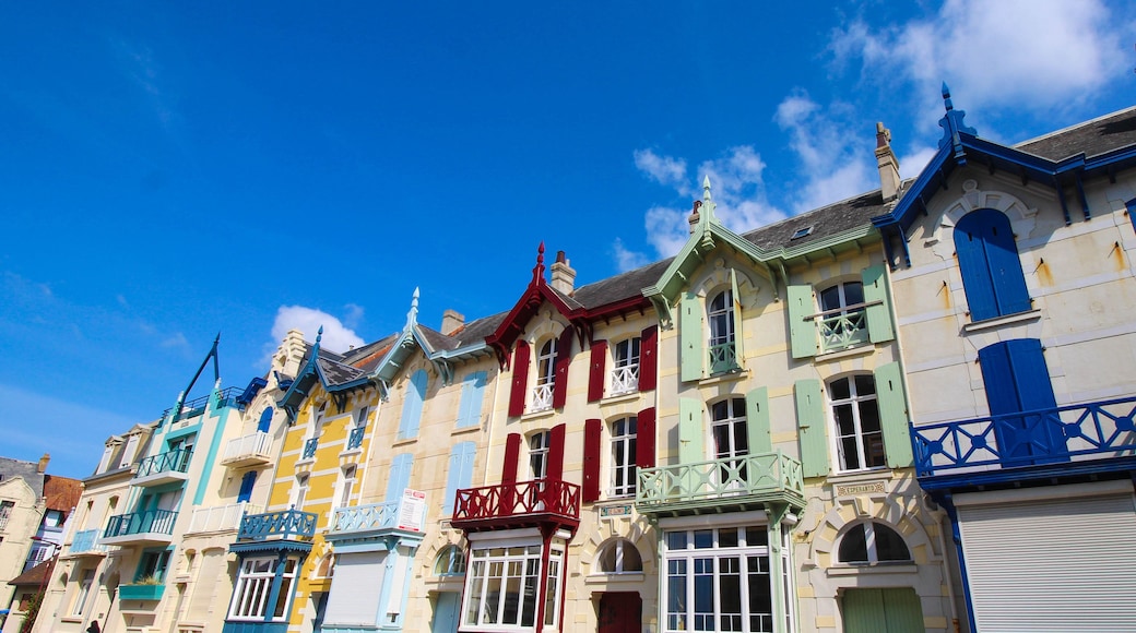 A row of colorful buildings with distinct architectural styles and balconies.