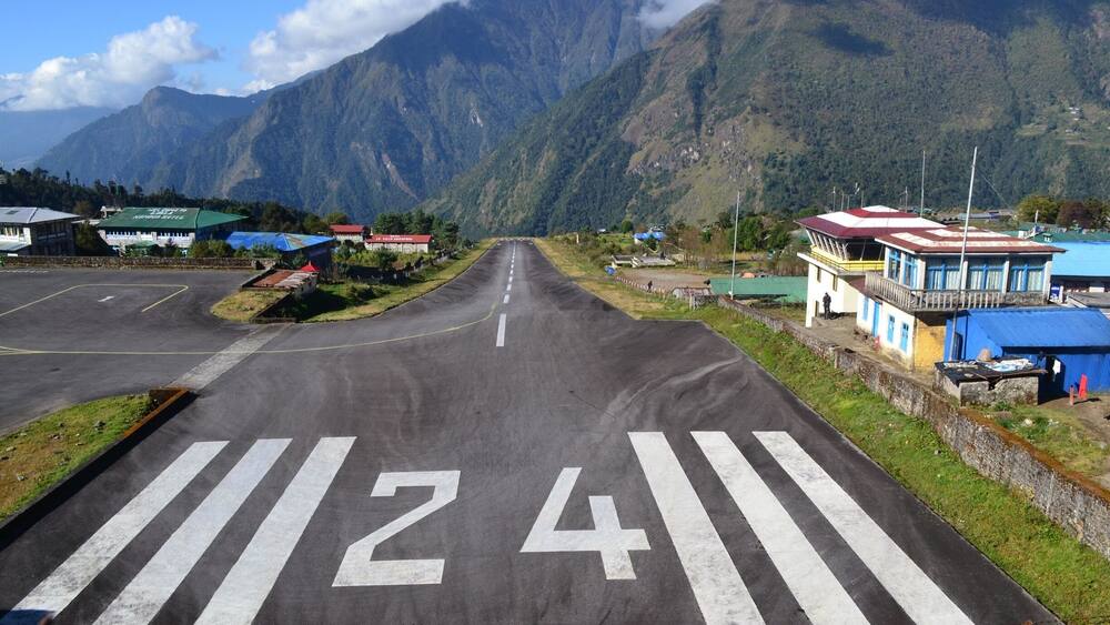 Lukla Airport one of most dangerous air strips in the world. Only 460 meters in length with a 50 meter elevation change from the bottom of the runway to the top and about a 9000 ft drop off at the end of the runway.