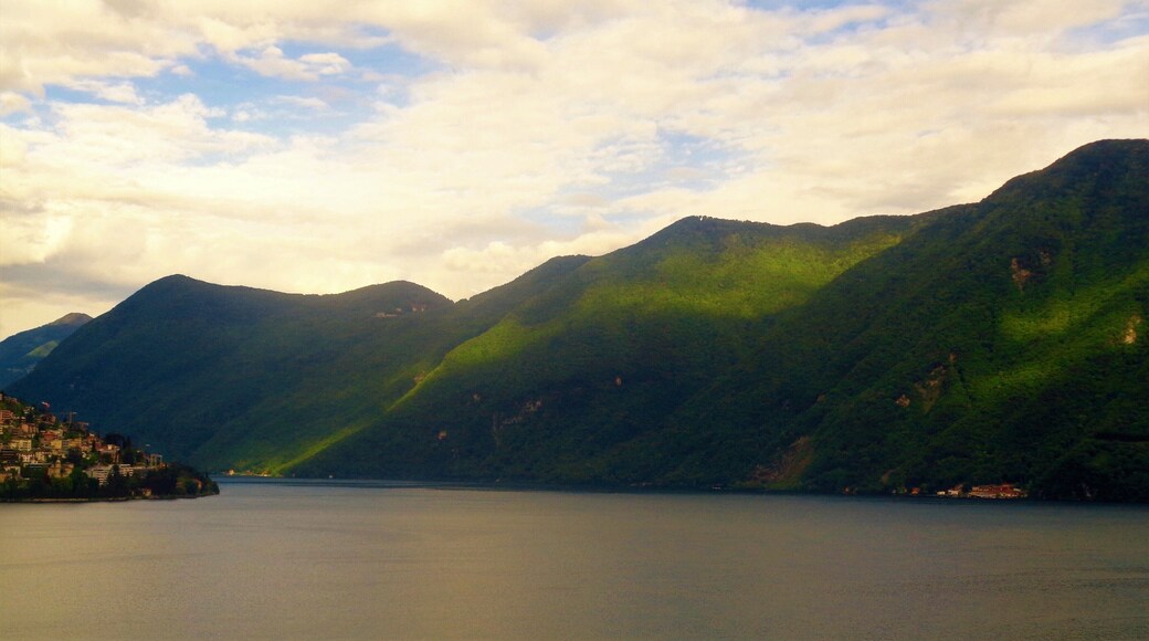 Lake Lugano in Ticino, Switzerland. This is a lush green view from Lugano city. It's the largest city in the Italian-speaking canton of Ticino (but still only the 9th largest city in Switzerland). The city has impressive culture and history but what most stands out are the natural views! I also went up to Monte Brè and Monte San Salvatore right by Lugano. The views from there are even more impressive!