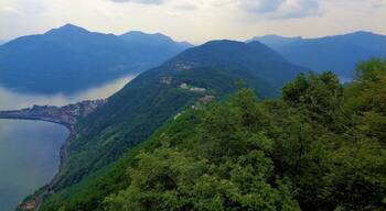 I took this photo from Monte San Salvatore in Ticino, Switzerland. It was a beautiful Spring moment! This spot gives great views of the mountains surrounding Lake Lugano! Usually, it is sunny and clear from here, but on that day, my only day on Monte San Salvatore, I got an atmospheric experience! And Monte San Salvatore is above the city of Lugano, so it's quite easy to get there!