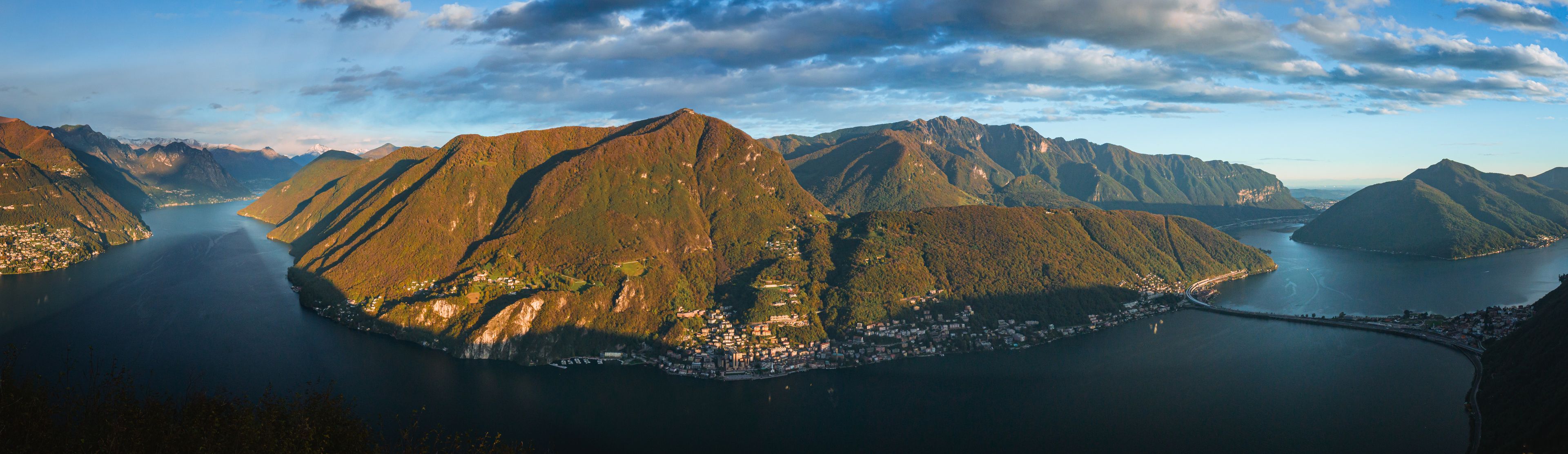 A mountainous landscape with a coastal town nestled between the hills.