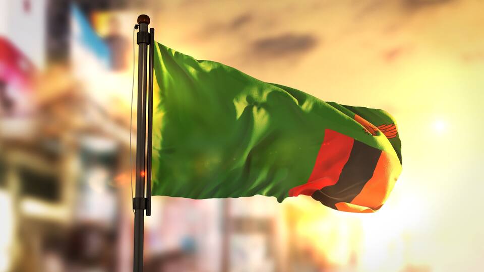 A flag on a pole with a blurred background.
