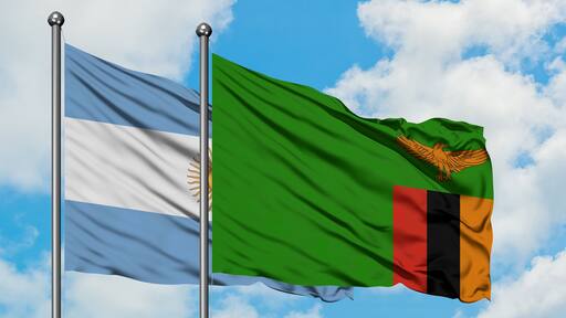 Argentina and Zambia flag waving in the wind against white cloudy blue sky together. Diplomacy concept, international relations.
