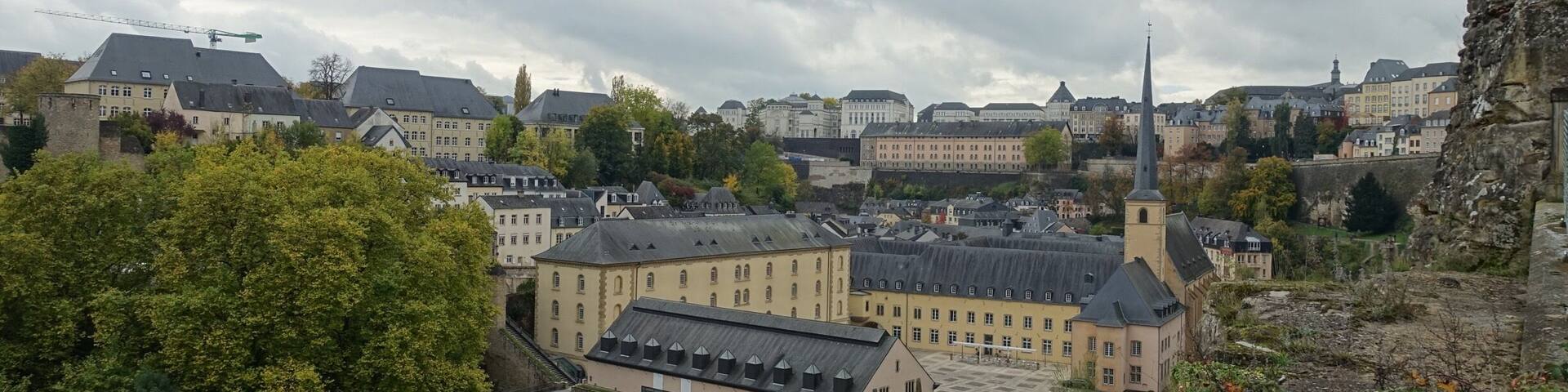 A historic town with a river, a bridge, and a prominent church spire.