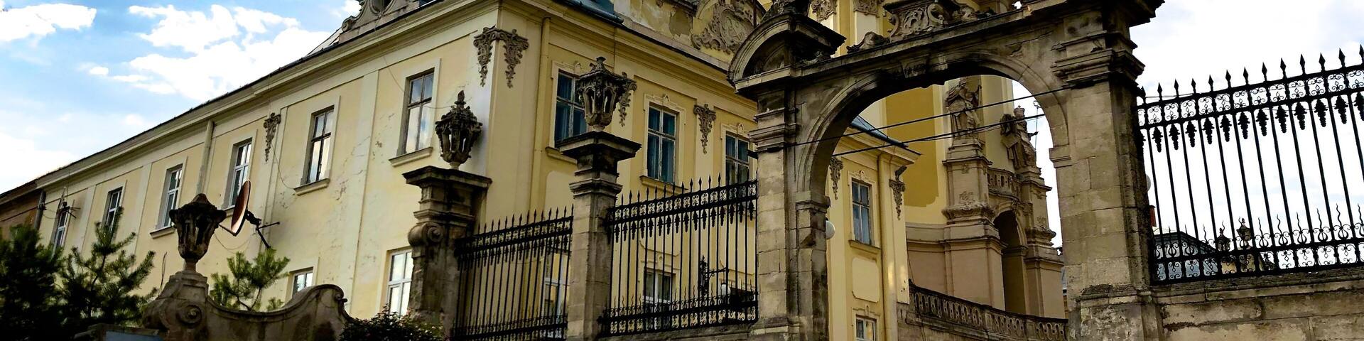 Located on St. George Hill, over-looking the city of Lviv, the church was the perfect target for destruction in the past. At least two versions of the St. George Cathedral were built before the final construction of the church as it is seen today. The Cathedral of St. George became the mother congregation of the Greek-Catholic religion in Ukraine.
The St. George Cathedral in Lviv, is home to one of the most treasured relics, which was brought to the cathedral by Bishop Jiseph Shumlianskyi in 1674. It is the Icon of the Virgin Mary, and is a spectacular and preserved artifact. The interior was decorated with luxurious embellishments created by the local artistic talents of Lviv. Pinsel, the sculptor of the cathedral, created the spectacular St. George (known as the Dragon Slayer) statue. The St. George statue can be viewed in the attic of the cathedral, while the intimidating statues of St. Athanasius and St. Leo protect the portal.
Renovations to the St. George Cathedral took place in the 1996, restoring the original beauty of the cathedral. Tourists, visiting this amazing historical masterpiece will not be disappointed. Over and above the cathedral, visitors can also visit the belfry, walk through the peaceful gardens or enter the final resting place of many important figures of the past in the tombs below the cathedral.