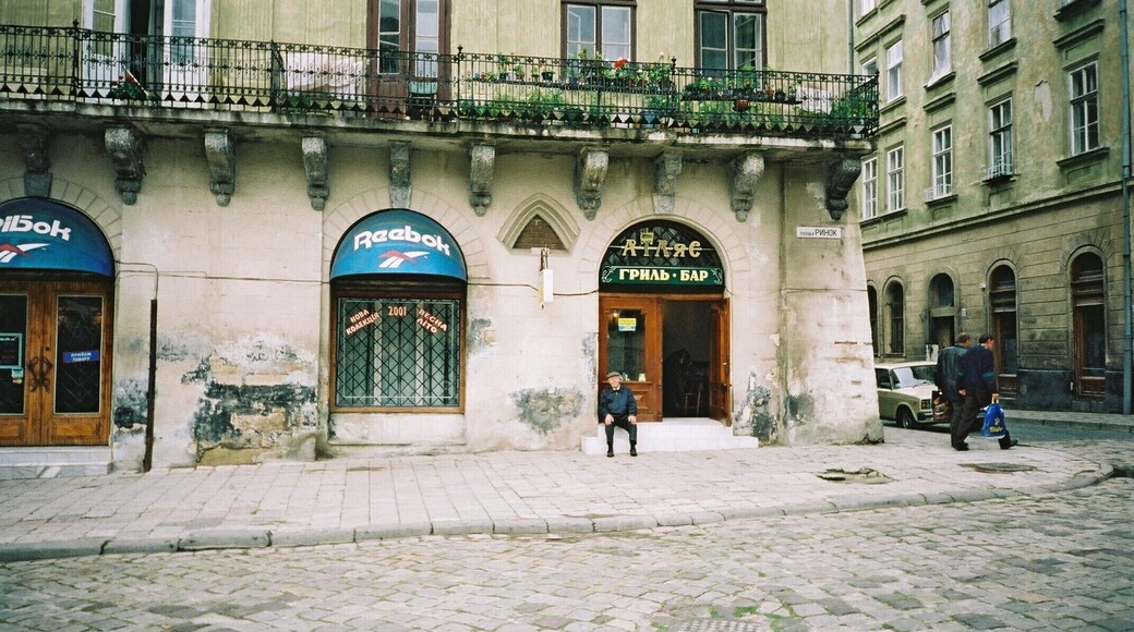 Artists' bar in the old town behind the town hall. My dad's first job was here around 1930 when. formerly, this was Lwow, Poland. He is pictured here in 2001 in his eighties sitting on the very same steps.