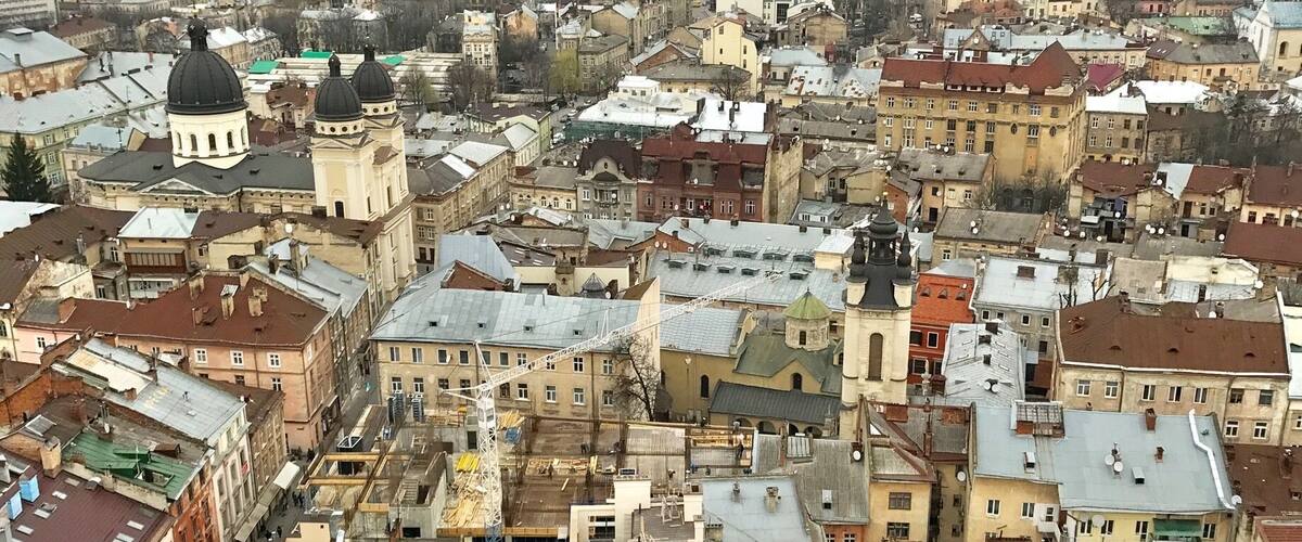 Lviv, Ukraine. Very European and Russian. Pay a small fee and climb 409 stairs in the bell tower for this lovely view.