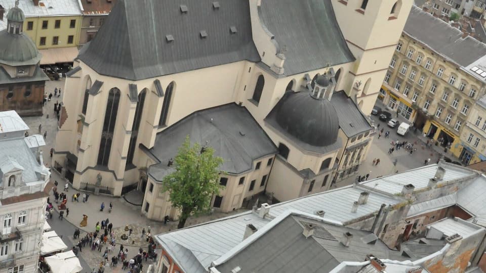 Lovely view of old Lviv from the top of the tower in the center of Ploscha Rynok. That's the Latin Cathedral, one of the oldest still-active churches in the city. To climb the tower, go up the first four flights of stairs to the ticket desk. The way is clearly marked with signs in multiple languages, including English. At the desk, pay 10 hrivna and then keep climbing up, up, and up until you reach the open deck at the top of the tower. Then enjoy the view!