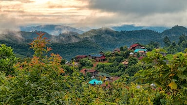 Beautifully Lit View of Traditional Akha Hill Tribe Village on Mountain Top Ridge in Nam Ha National Protected Area. Ethnic Village in Laotian with Dramatic Morning Sunrise (Luang Namtha, Laos)., Shut