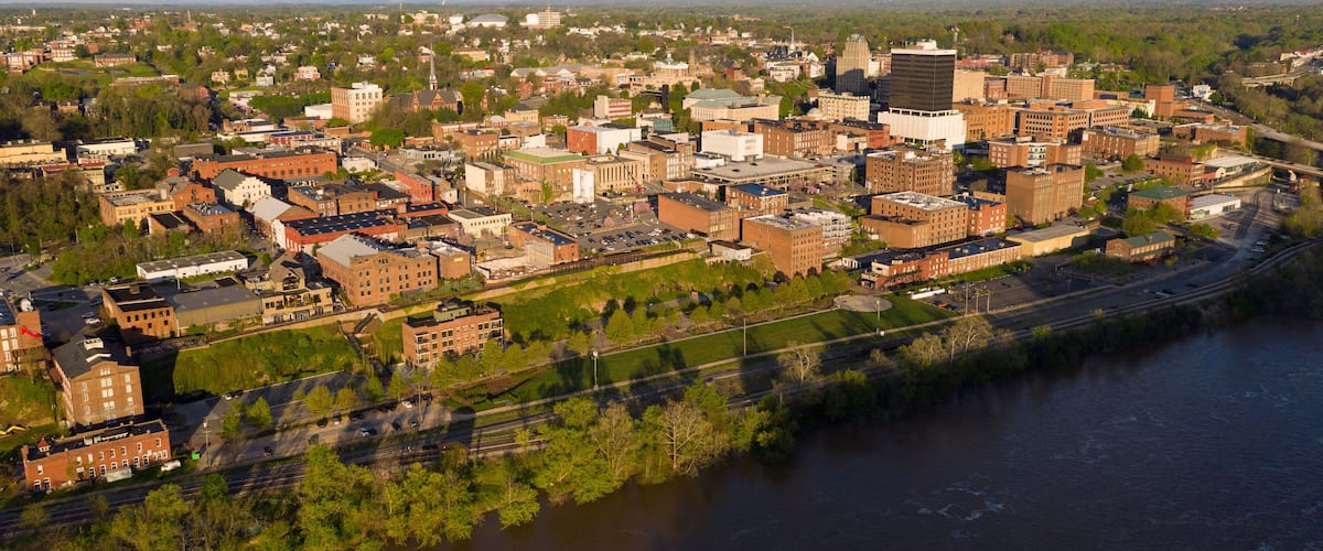 A river running through a city with historic buildings and a bridge.