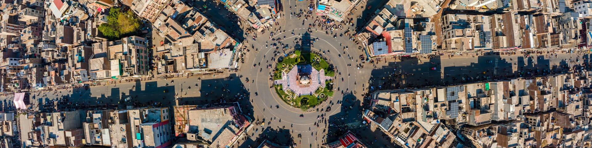 Aerial view of the Clock Tower Faisalabad and its iconic eight radiating streets surrounded by dense urban architecture and rooftops in Faisalabad, Punjab, Pakistan.