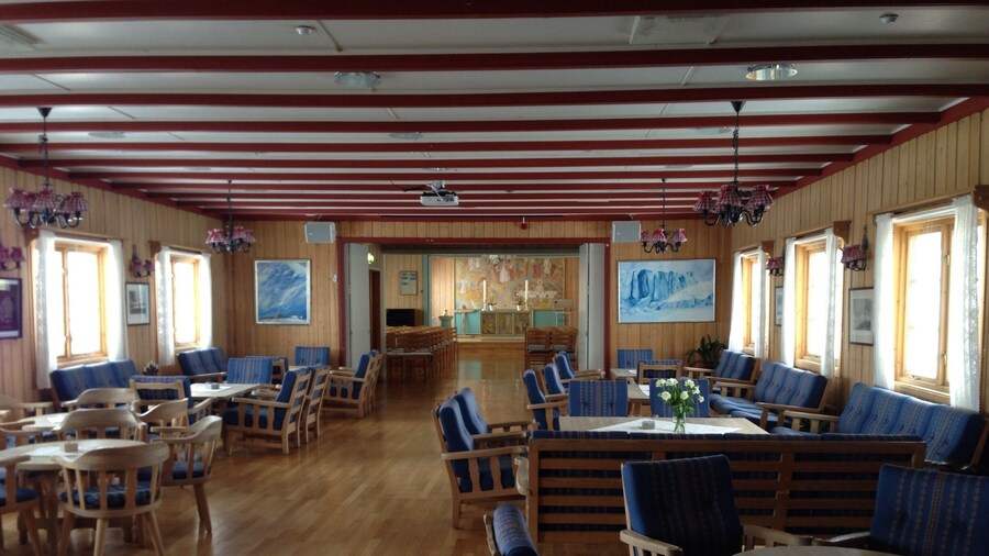 Inside the northernmost church in the world! The Svalbard church sits on a hill overlooking Longyearbyen. It's got a lovely fireside community room with wooden tables and Scandinavian-patterned cushions and then a church hall with an altar and small touches throughout that remind you exactly where you are on top of the world. It's a very nice, peaceful place to take pause.