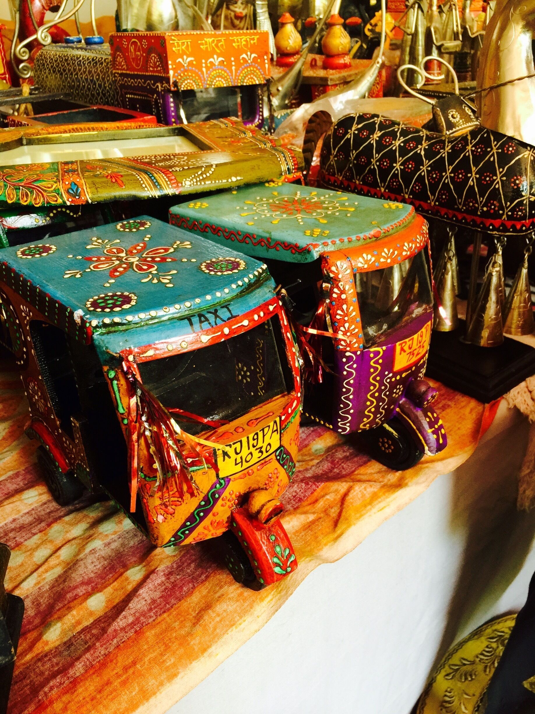 Valluvar Kottam has a ten day long National Silk Expo every year in July. Craftsmen from all over the country bring their wares and sell them at the Expo. This was a stall from Jodhpur, Rajasthan. Colorful wooden dolls, foyer tables, vases, collectibles and frames on sale here. This is a miniature of an "Autorickshaw"- a form of public transport in India. 
#colorful