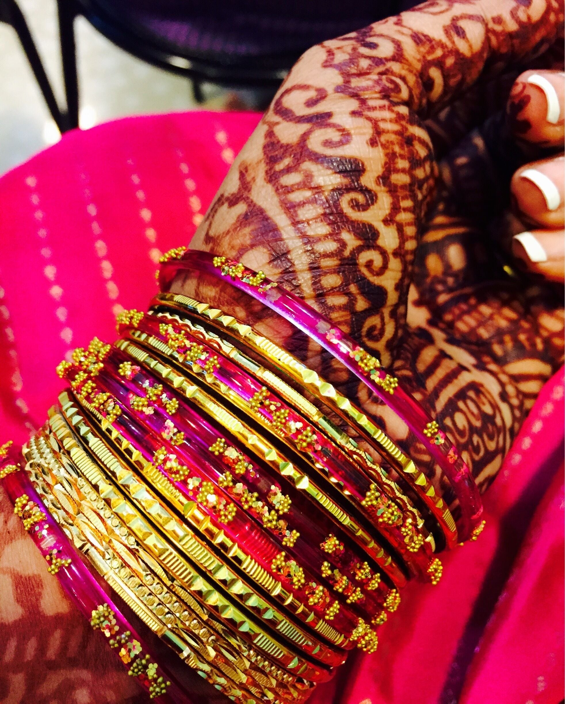 Colorful glass bangles and pretty henna. Bangle shops that sell colorful bangles to match the colors in your sarees!!! 
#riotofcolors 
#colorful 
