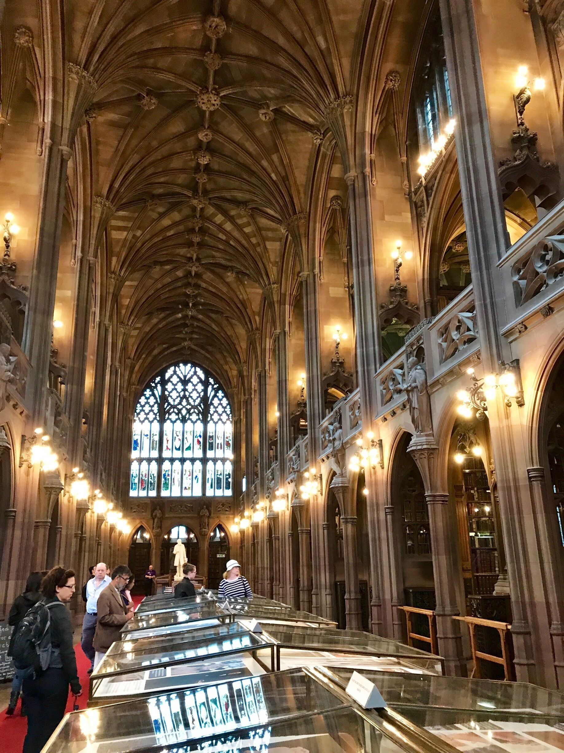 The architectural style is primarily neo-Gothic with elements of Arts and Crafts Movement in the ornate and imposing gatehouse facing Deansgate which dominates the surrounding streetscape. The library, granted Grade I listed status in 1994, is maintained by the University of Manchester and open for library readers and visitors.
