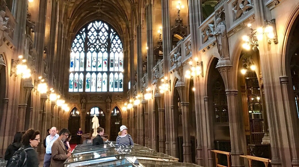 The architectural style is primarily neo-Gothic with elements of Arts and Crafts Movement in the ornate and imposing gatehouse facing Deansgate which dominates the surrounding streetscape. The library, granted Grade I listed status in 1994, is maintained by the University of Manchester and open for library readers and visitors.