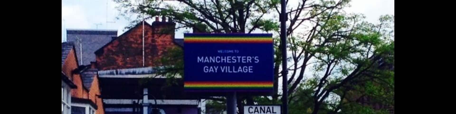 A sign for Manchester's Gay Village and Canal Street.