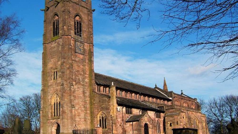 A historic church with a tall tower and arched windows.